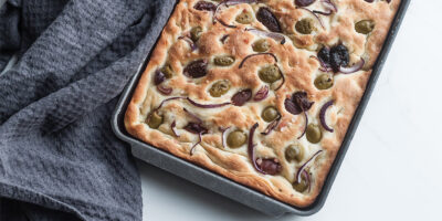 focaccia, wloski chlebek z oliwkami, czerwona cebula i sola